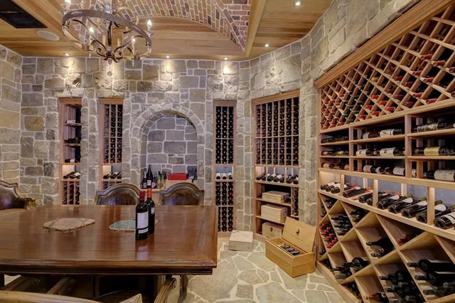 a kitchen with stainless steel appliances granite countertop a sink table and chairs