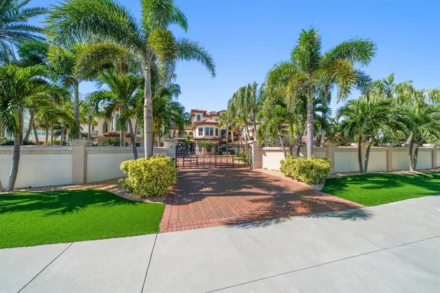 a open kitchen with stainless steel appliances kitchen island granite countertop a table chairs and a refrigerator