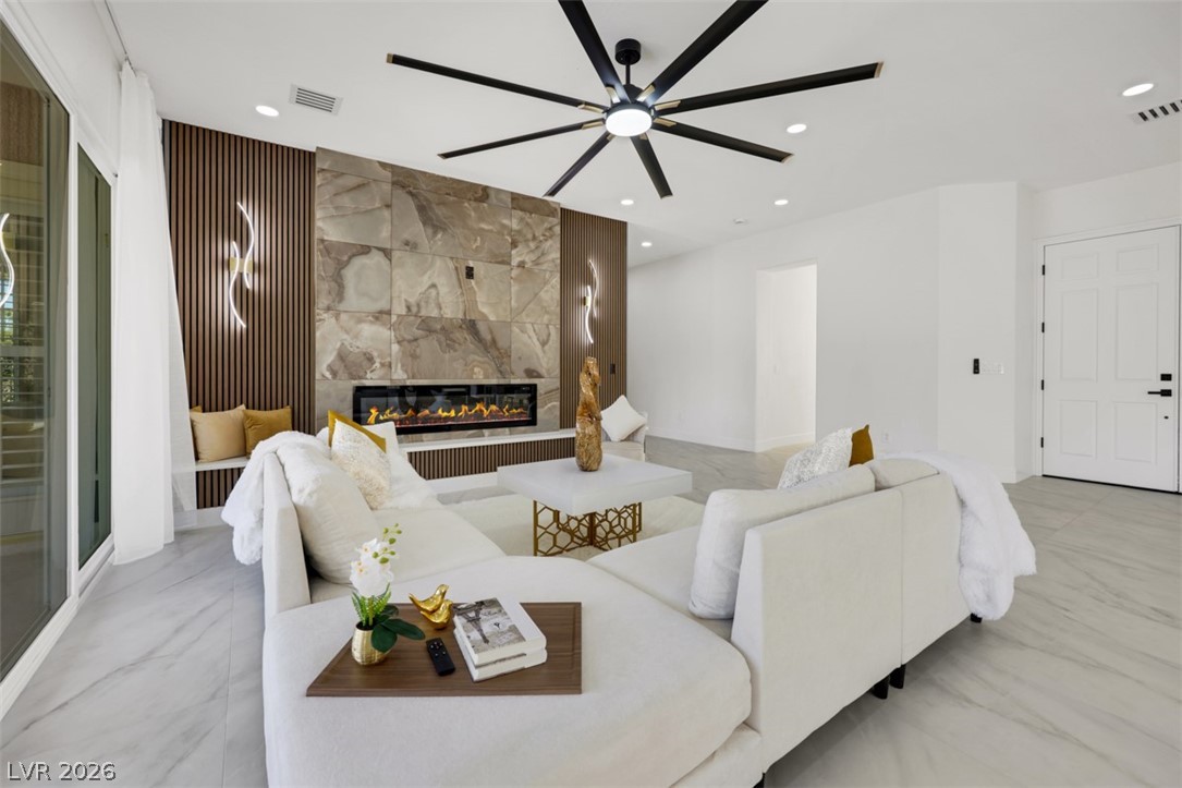 5015 Rivedro Street Las Vegas, NV 89135 - Photo 21 of 91 Architectural paneling and a modern linear fireplace create a sophisticated focal point in this inviting gathering space.
