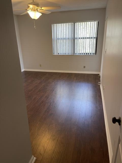 12628 Shoreline Drive, Unit 9C Wellington, FL 33414 - Photo 15 of 32 an empty room with wooden floor and windows