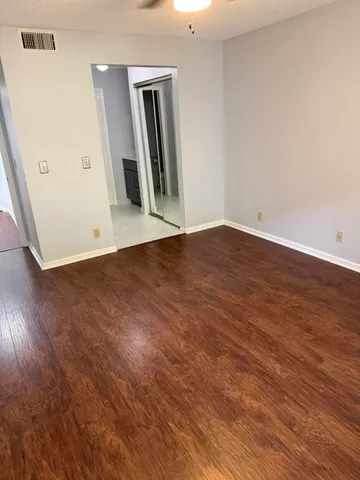 an empty room with wooden floor