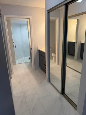 a view of a hallway to rooms