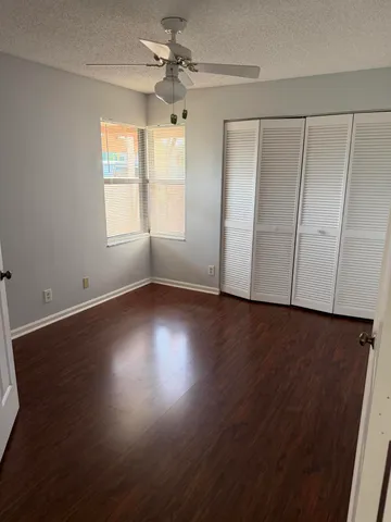 a view of wooden floor and windows in a room