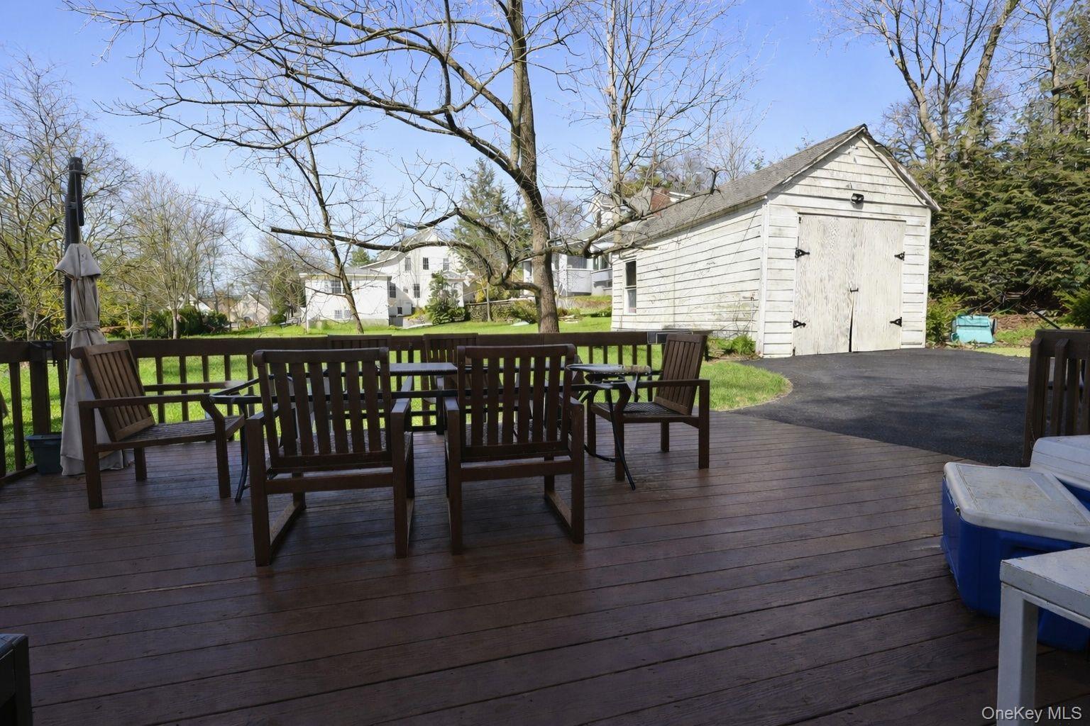 90 South Middletown Road Pearl River, NY 10965 - Photo 14 of 47 a view of a roof deck with table and chairs barbeque oven and floor to ceiling window