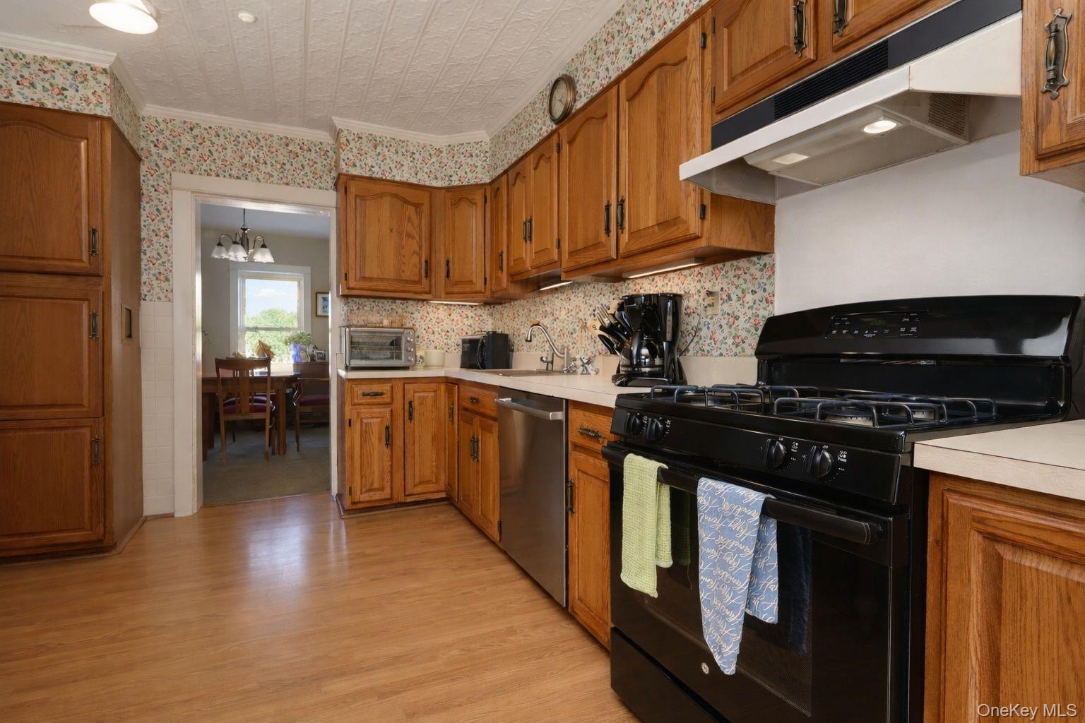 90 South Middletown Road Pearl River, NY 10965 - Photo 21 of 47 a kitchen with stainless steel appliances granite countertop a stove top oven a sink dishwasher and a refrigerator with wooden floor