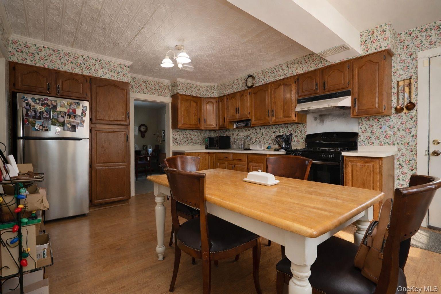90 South Middletown Road Pearl River, NY 10965 - Photo 22 of 47 a kitchen with stainless steel appliances wooden floor dining table and chairs