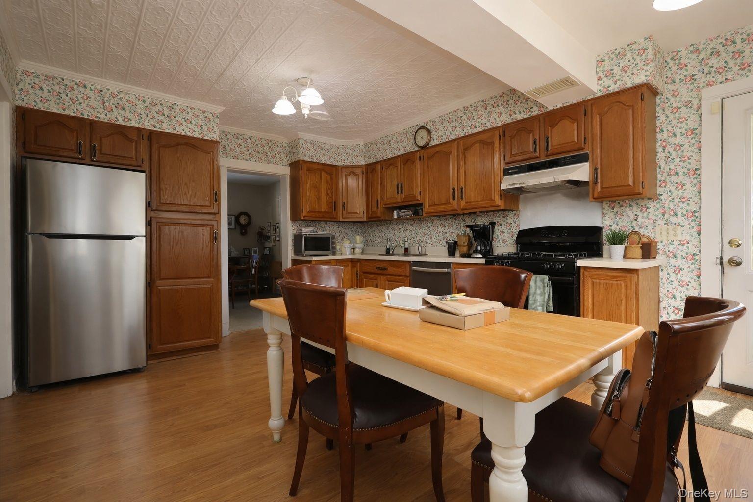 90 South Middletown Road Pearl River, NY 10965 - Photo 24 of 47 a kitchen with stainless steel appliances wooden floor dining table and chairs