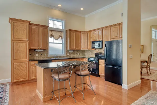 a kitchen with stainless steel appliances granite countertop a refrigerator and a stove top oven