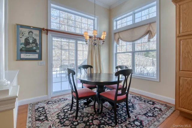a view of a dining room with furniture wooden floor and a chandelier