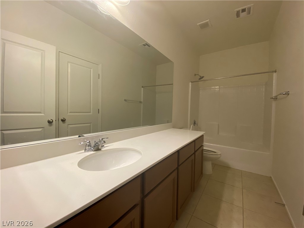 436 Cadence View Way Henderson, NV 89011 - Photo 30 of 36 A pristine bathroom features a single vanity, a spacious mirror, and a convenient shower-over-tub combination.