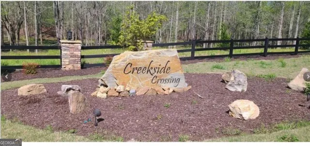 a view of a backyard with wooden fence