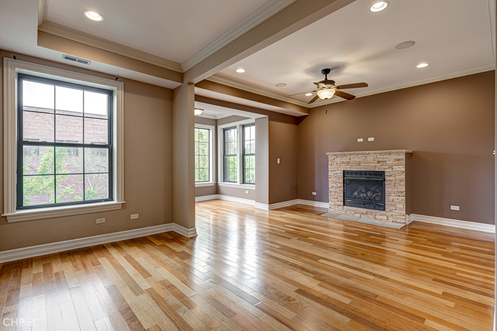 1363 East 64th Street, Unit 2 Chicago, IL 60637 - Photo 2 of 12 a view of an empty room with wooden floor fireplace and a window