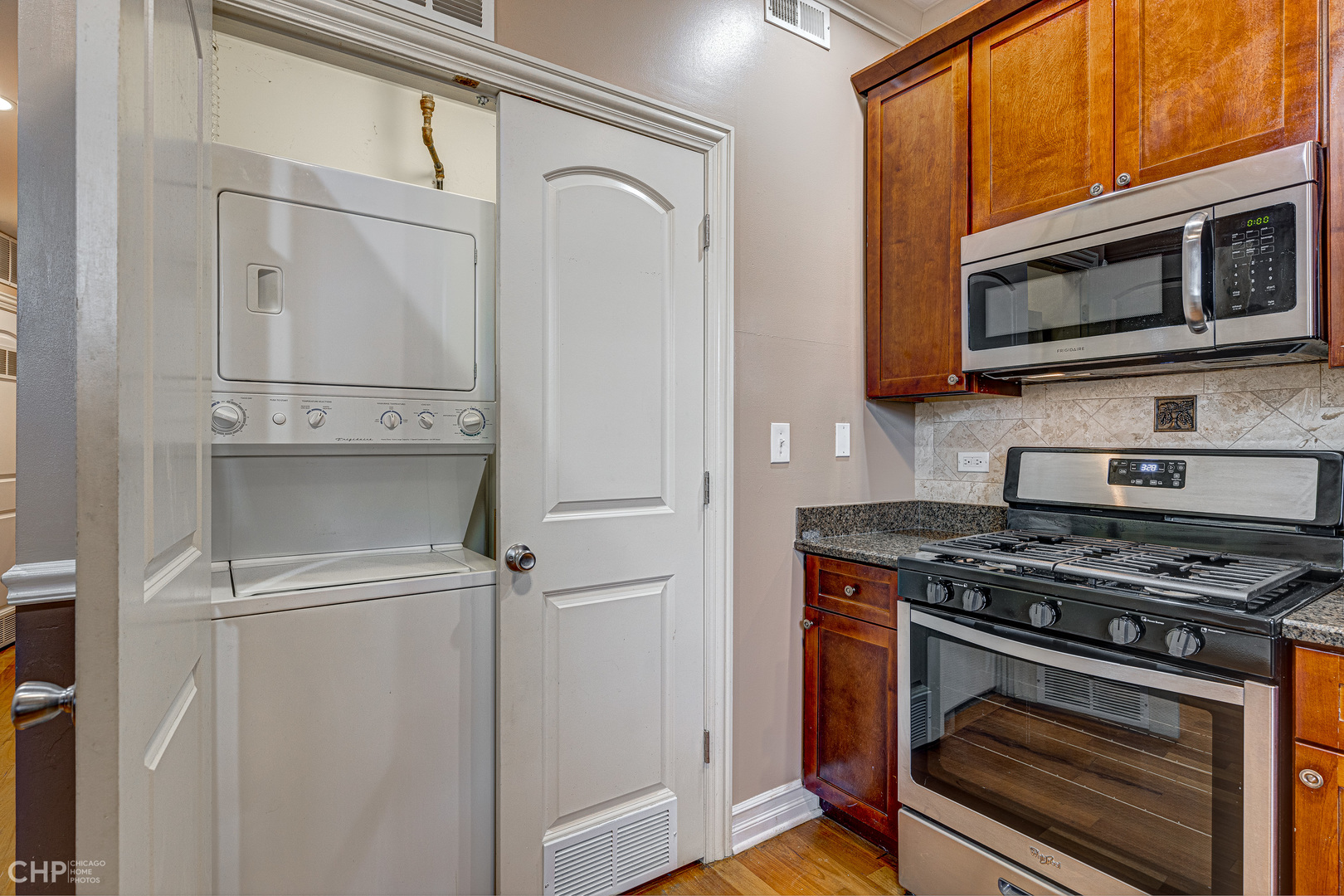 1363 East 64th Street, Unit 2 Chicago, IL 60637 - Photo 9 of 12 a kitchen with stainless steel appliances white cabinets and a stove top oven