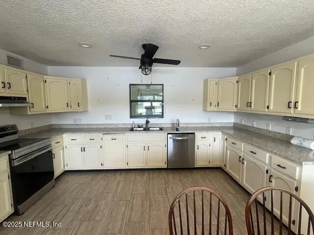 a kitchen with granite countertop white cabinets white stainless steel appliances with a sink and dishwasher
