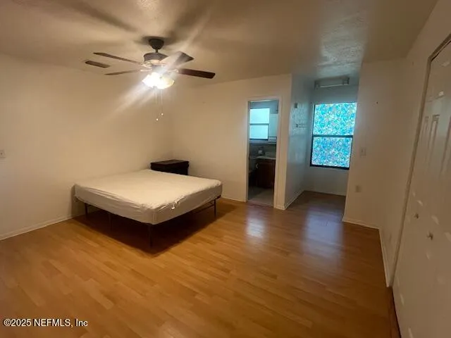 a bedroom with bed and window