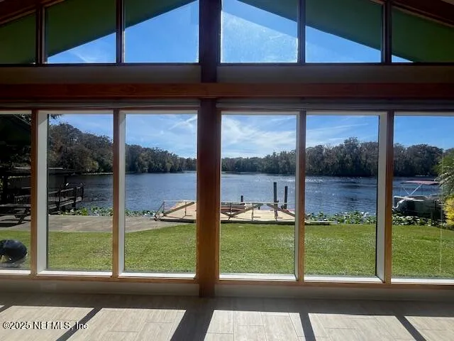 a view of a glass door with a yard from a window