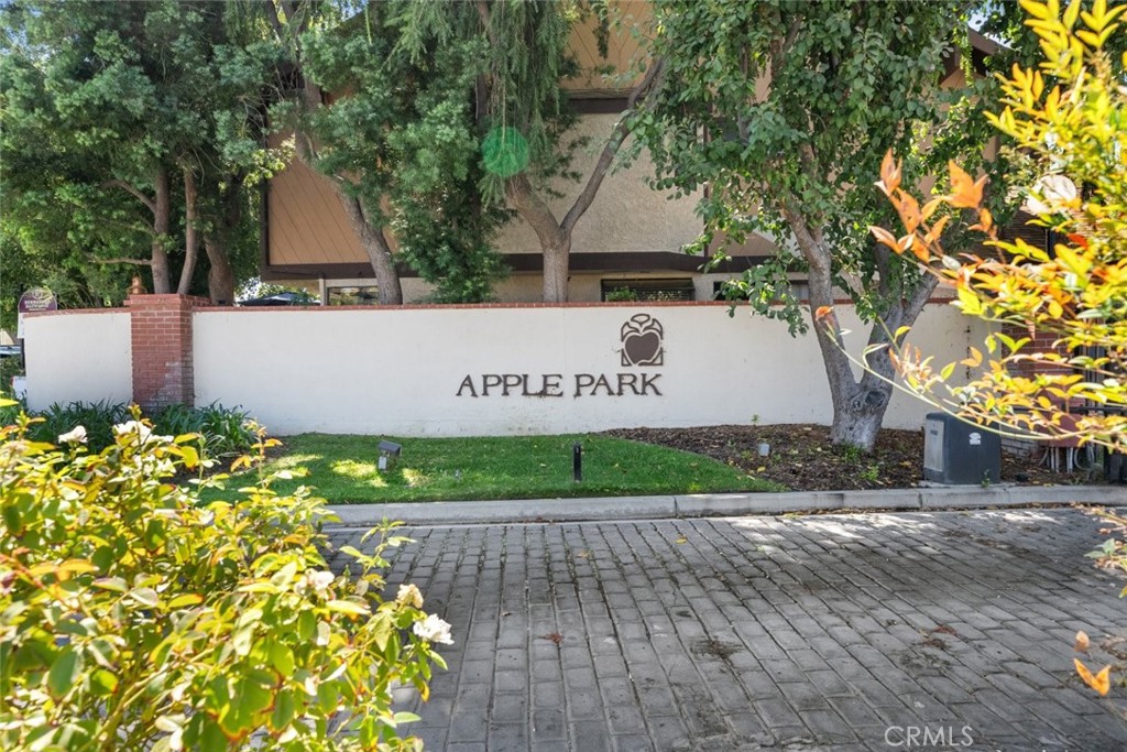 24843 Apple Street, Unit B Newhall, CA 91321 - Photo 1 of 1 a sign on the side of a building