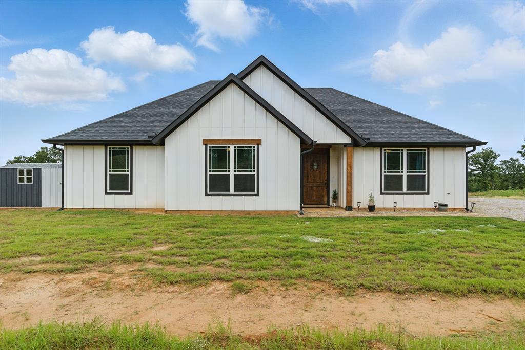 3385 Dps Tower Road Perrin, TX 76486 - Photo 1 of 35 a front view of the house with a garden