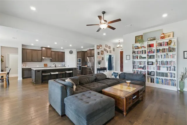 a living room with furniture kitchen and a view of kitchen