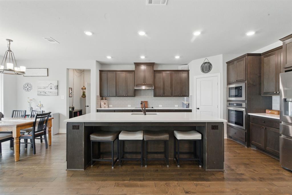 3385 Dps Tower Road Perrin, TX 76486 - Photo 13 of 35 a large kitchen with a table and chairs