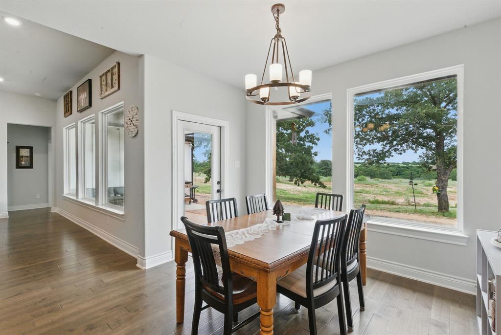 3385 Dps Tower Road Perrin, TX 76486 - Photo 17 of 35 a view of a dining room with furniture window and wooden floor