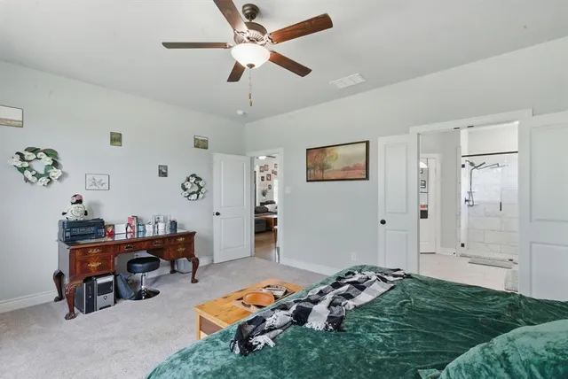 a bedroom with furniture and a chandelier fan