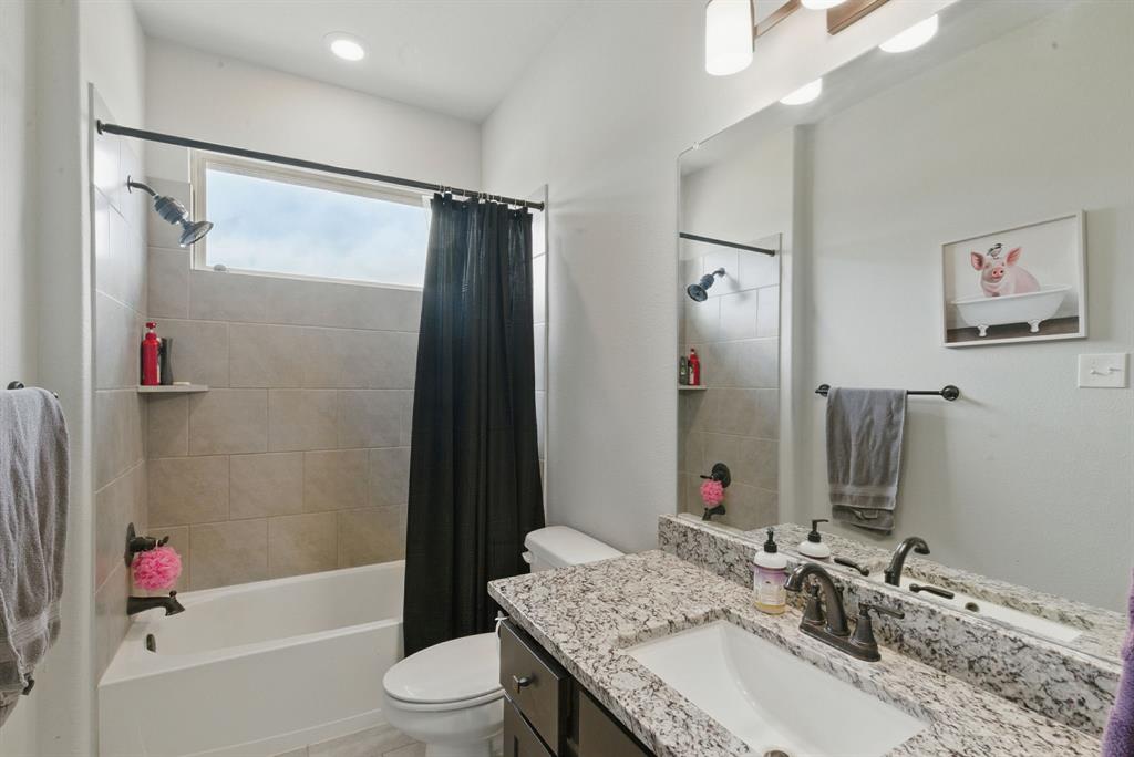 3385 Dps Tower Road Perrin, TX 76486 - Photo 28 of 35 a bathroom with a granite countertop sink toilet and shower