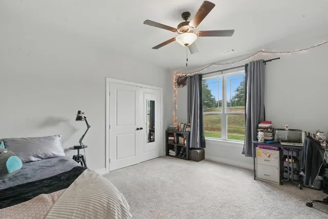 a bed room with furniture and a window