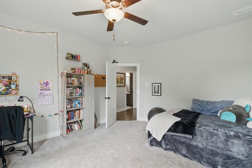 3385 Dps Tower Road Perrin, TX 76486 - Photo 31 of 35 a bedroom with a bed and a chandelier