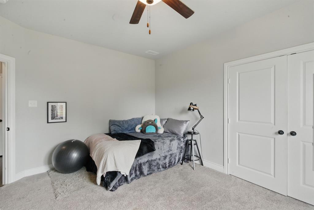 3385 Dps Tower Road Perrin, TX 76486 - Photo 32 of 35 a bedroom with a bed and a chandelier