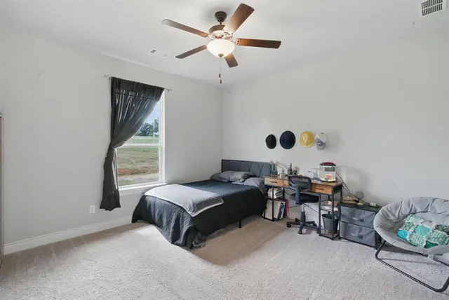 a bedroom with bed and a window