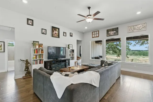 a living room with fireplace furniture and a flat screen tv