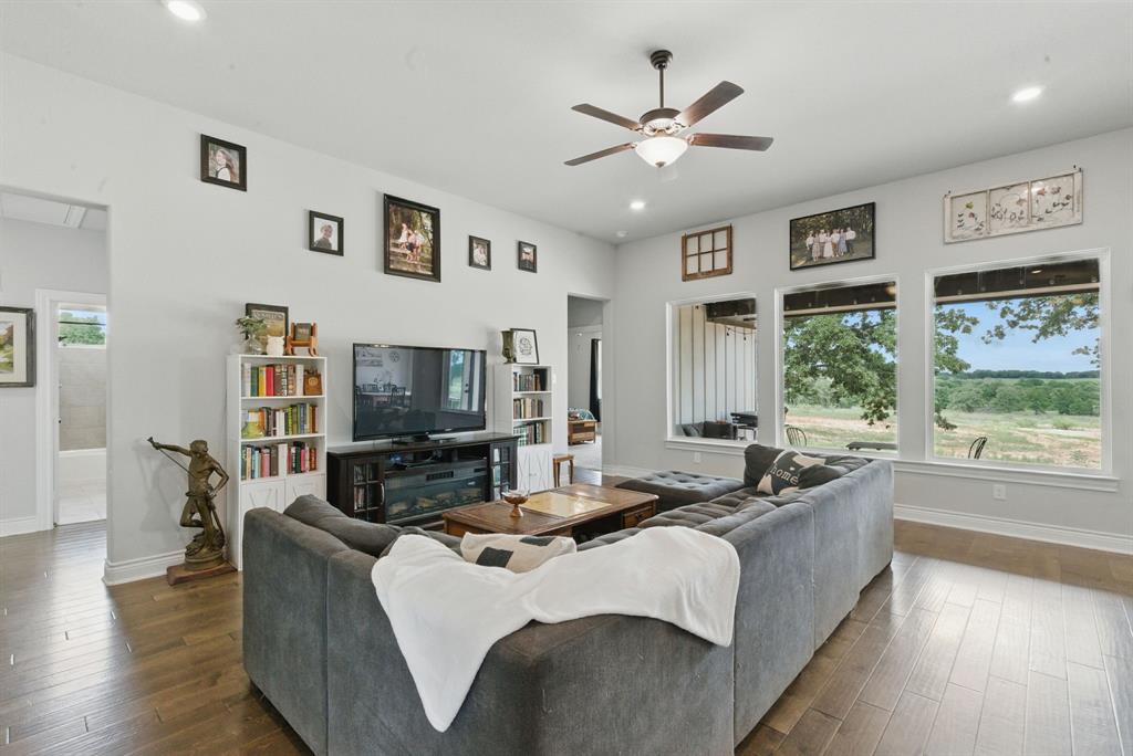 3385 Dps Tower Road Perrin, TX 76486 - Photo 9 of 35 a living room with fireplace furniture and a flat screen tv