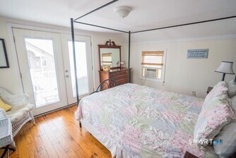 127 Shore Road Clinton, CT 06413 - Photo 17 of 20 a bedroom with a bed and a dresser next to a window