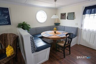 127 Shore Road Clinton, CT 06413 - Photo 4 of 20 a view of a dining room with furniture and wooden floor