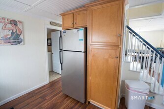 127 Shore Road Clinton, CT 06413 - Photo 8 of 20 a view of hallway with wooden floor and staircase
