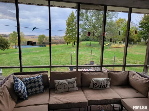 a living room with couch and a floor to ceiling window