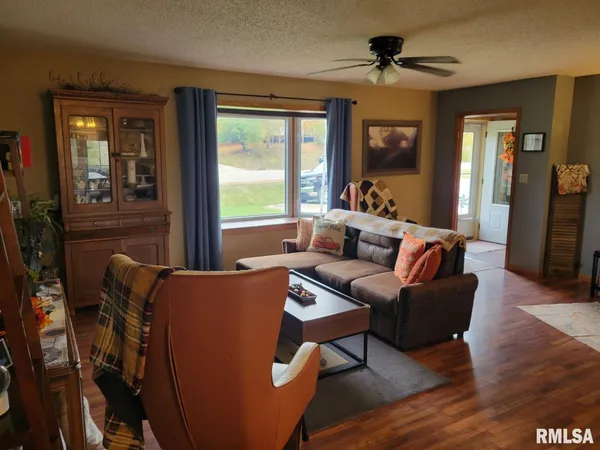 a living room with furniture and a piano
