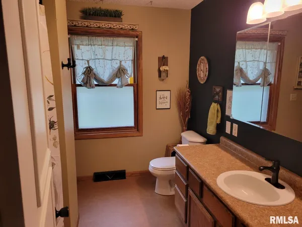 a bathroom with a sink and mirror with bathtub
