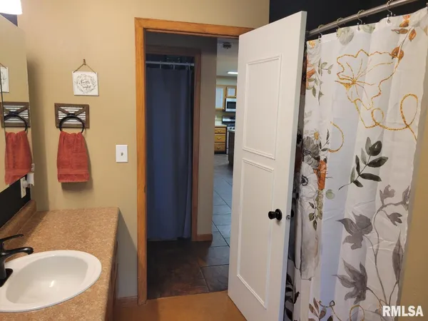 a bedroom with a bed and a dresser in it