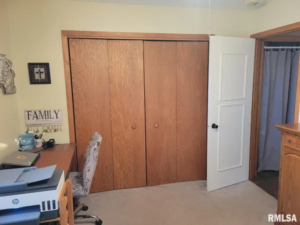 a bedroom with a bed and walk in closet