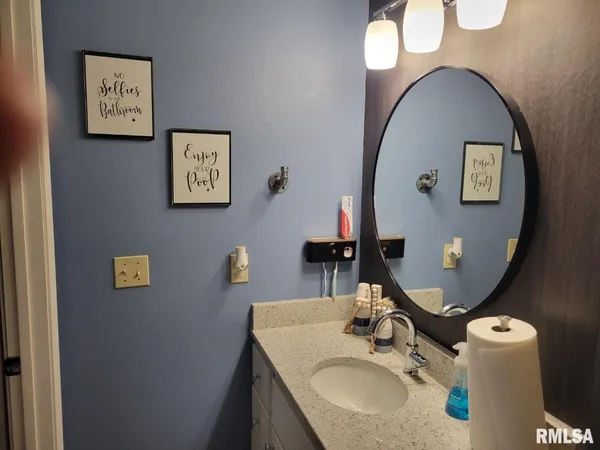 a bathroom with a sink toilet and a window