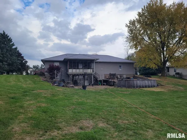 a view of a house with a yard and sitting area