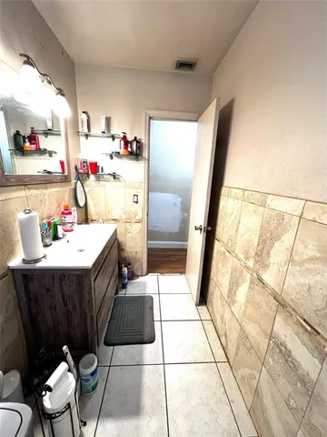 a bathroom with a sink mirror and shower