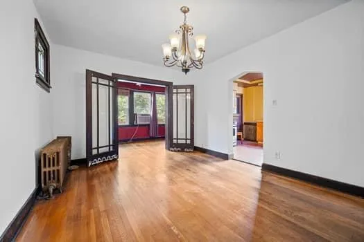 a view of a livingroom with wooden floor and furniture