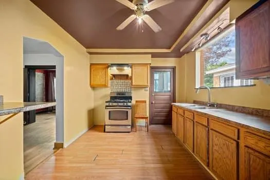 a kitchen with stainless steel appliances a stove a sink and a refrigerator