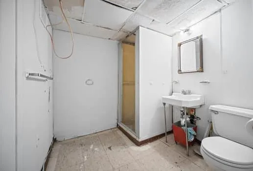 a bathroom with a toilet sink and shower