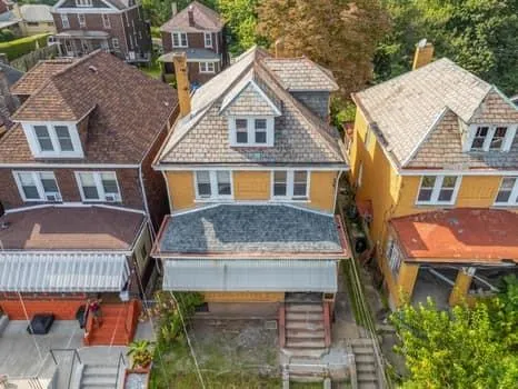 a aerial view of a house with a yard