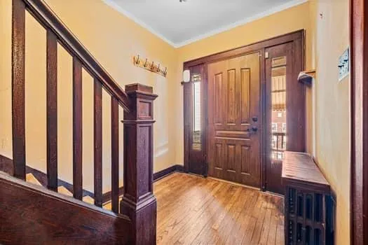a view of a hallway with wooden floor and staircase