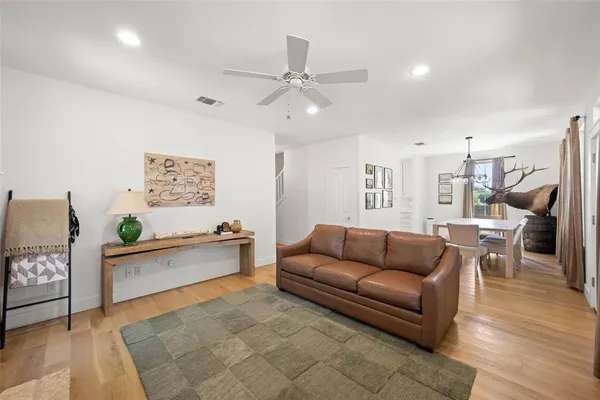 a living room with furniture and kitchen view